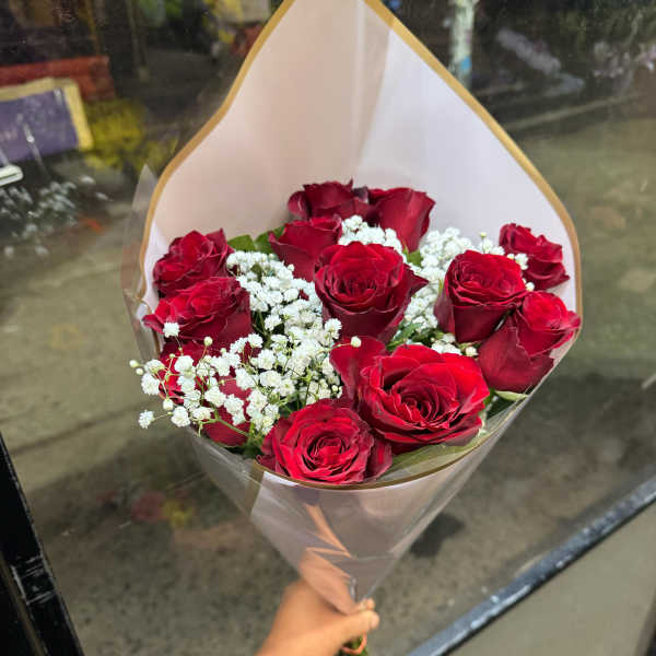 Bouquet of red roses with white baby's breath in clear wrap