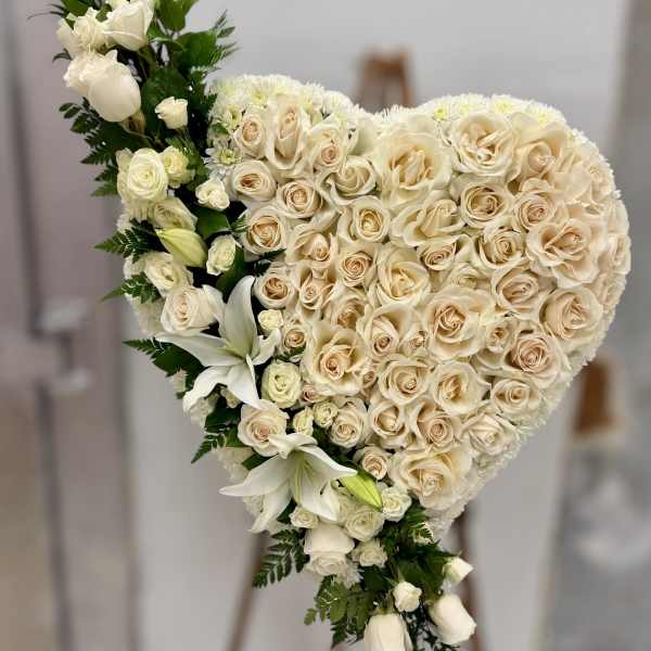 Heart-shaped bouquet of cream roses and white lilies