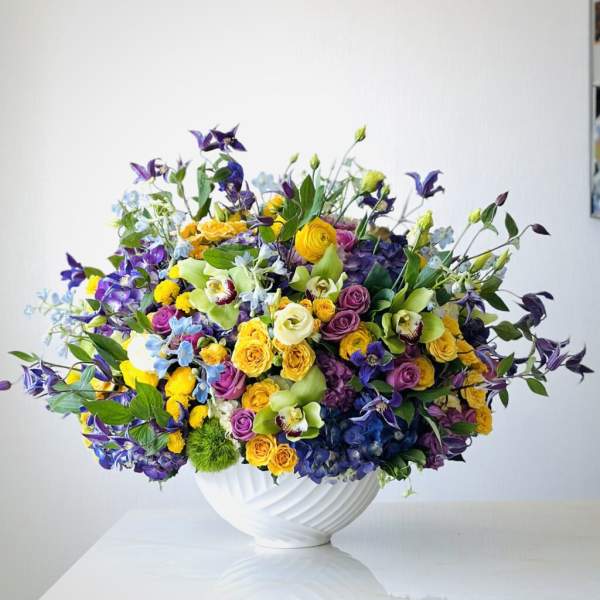 Colorful mixed bouquet in a white vase