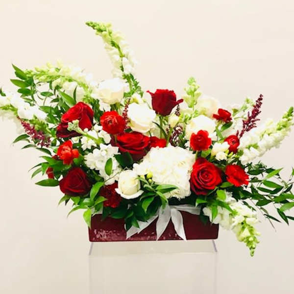 Red and white rose arrangement in a rectangular box