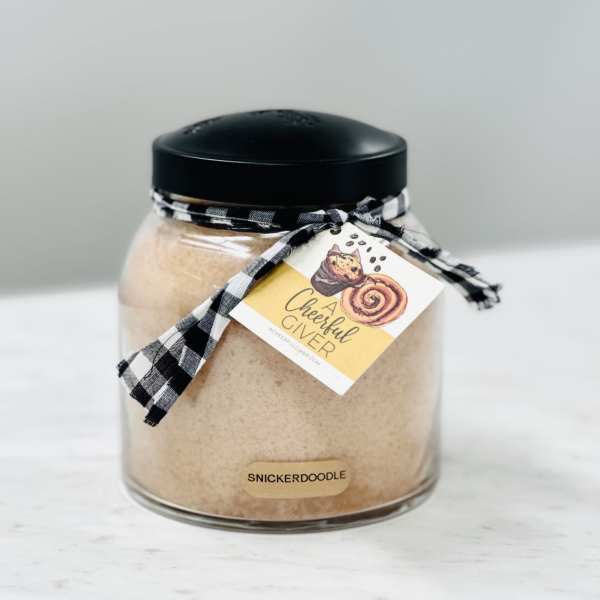 Jar of snickerdoodle mix with a black lid and ribbon tag