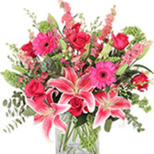 Pink lilies and roses in a clear glass vase