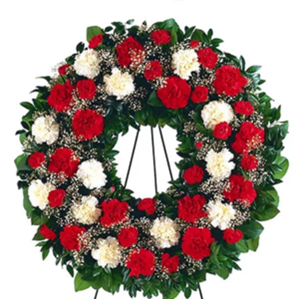 Red and white carnation wreath on a standing easel
