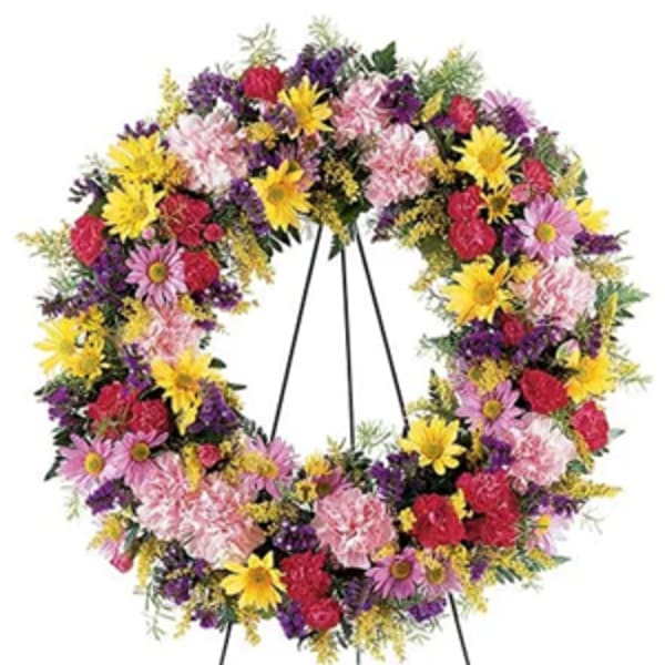 Colorful floral wreath on a metal easel stand