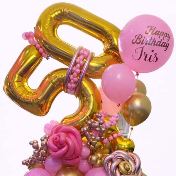 Pink and gold birthday balloon arrangement with a personalized balloon