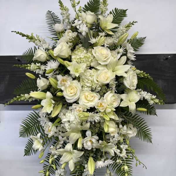 Large white floral standing spray with roses and lilies