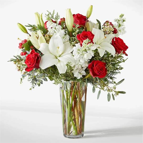 Red roses and white lilies in a clear glass vase