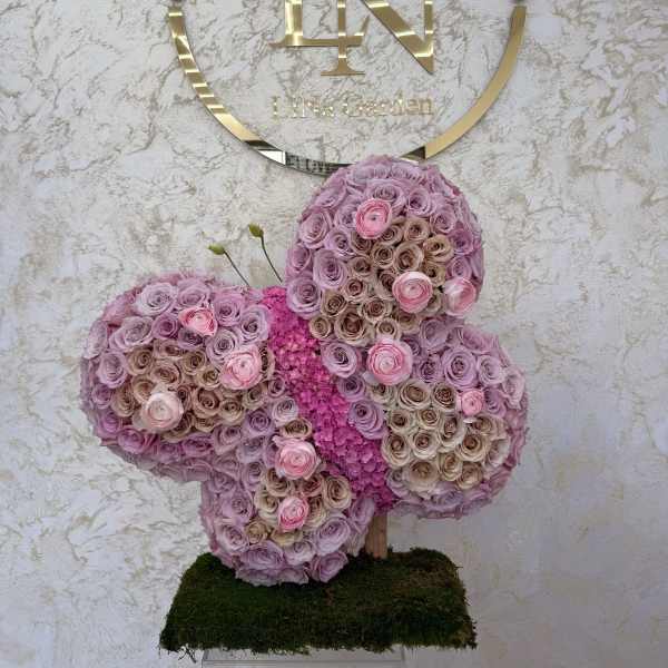 Butterfly-shaped floral arrangement of pink and lavender roses