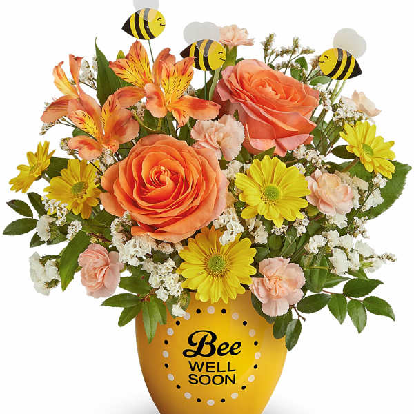 Orange and yellow flower arrangement in a bee-themed pot with bee picks