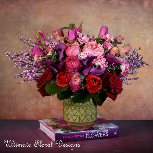 Pink and red mixed bouquet in a patterned vase
