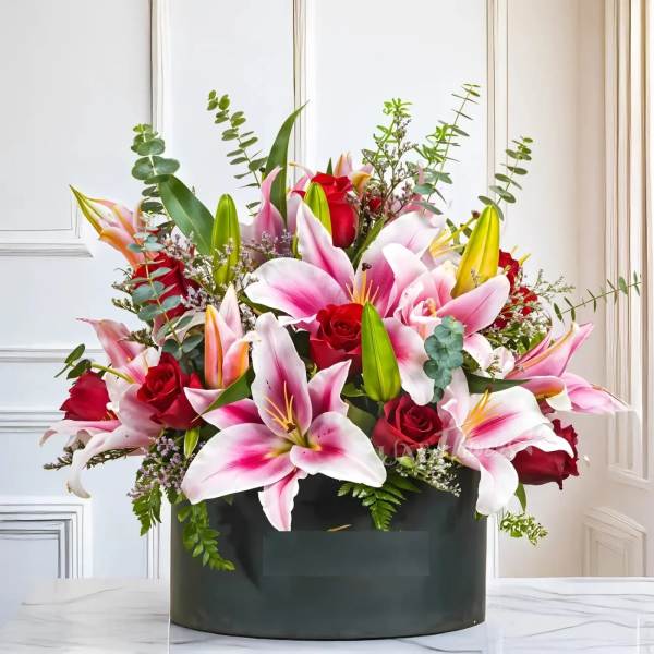 Pink lilies and red roses in a black box arrangement