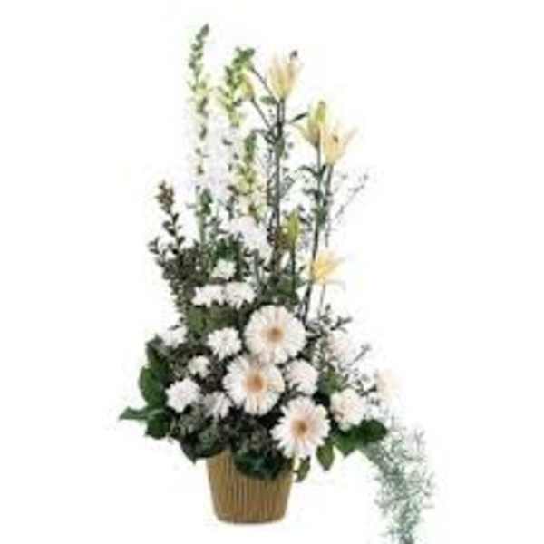 White daisy arrangement in a woven basket with tall yellow blooms