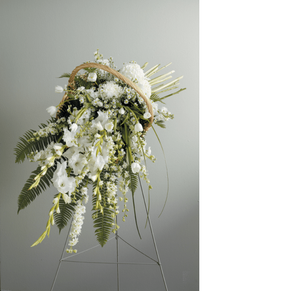 White floral spray on a stand with a woven handle