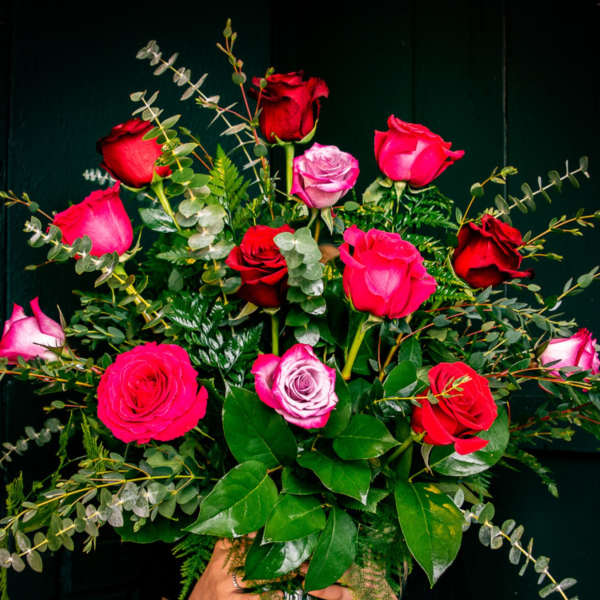 Bouquet of red and pink roses in a clear glass vase