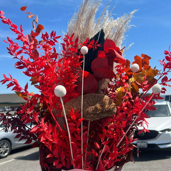Tall red foliage arrangement with pampas grass and decorative stems