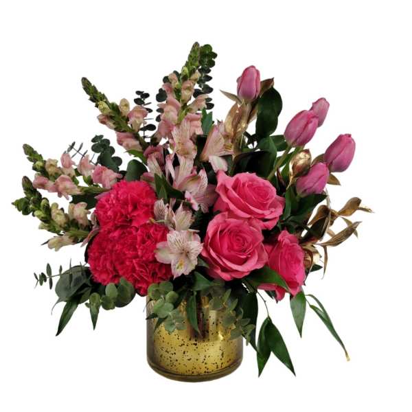Pink roses and carnations in a gold vase with mixed greenery