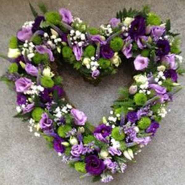 Heart-shaped floral wreath in purple, lavender, white, and green