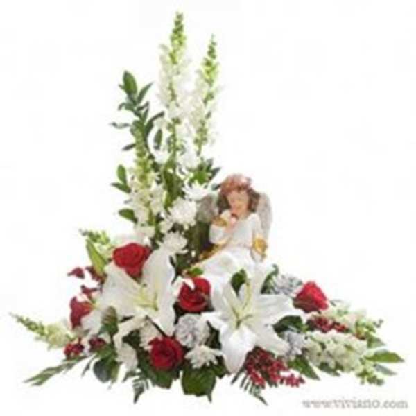 White lilies and red roses arranged around a small angel figurine