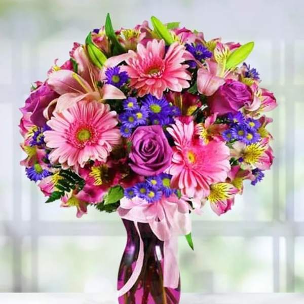 Pink and purple mixed bouquet in a glass vase