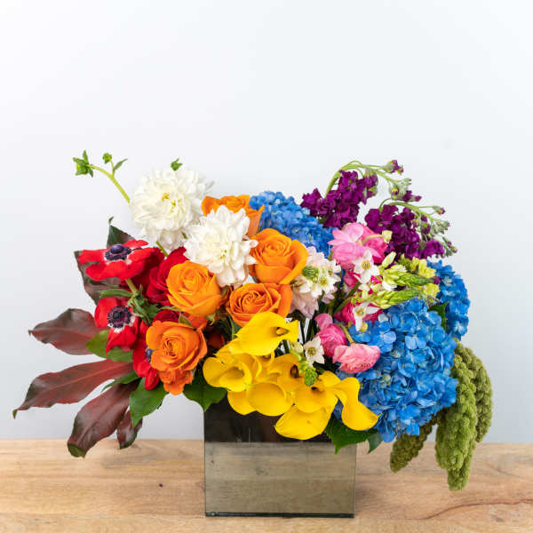 Colorful mixed bouquet in a square glass vase