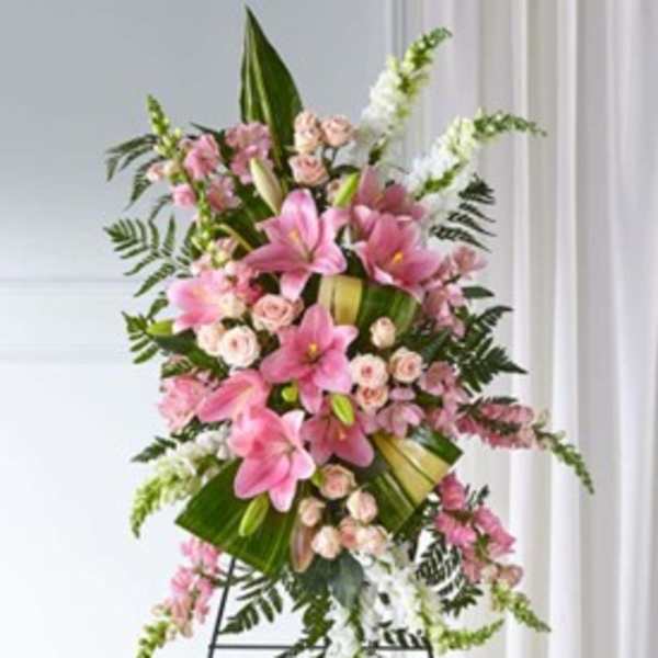 Tall pink lily and rose standing spray on an easel