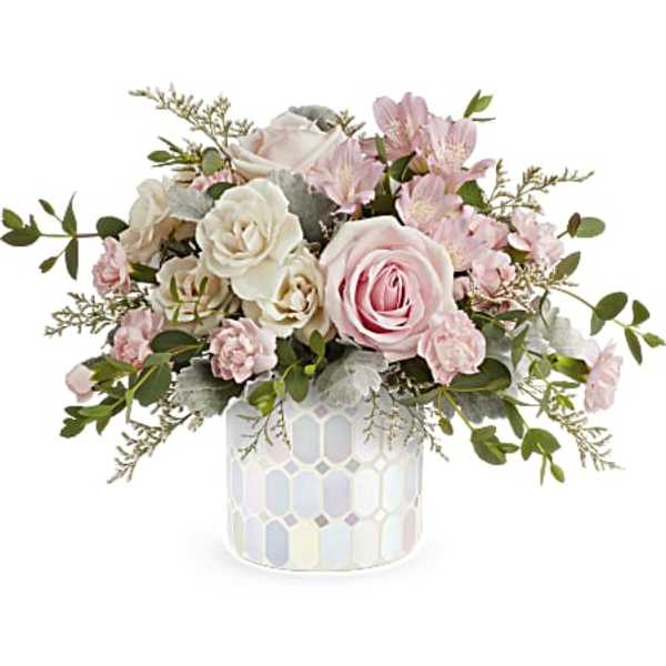 Pink and white roses with small pink blooms in a mosaic vase