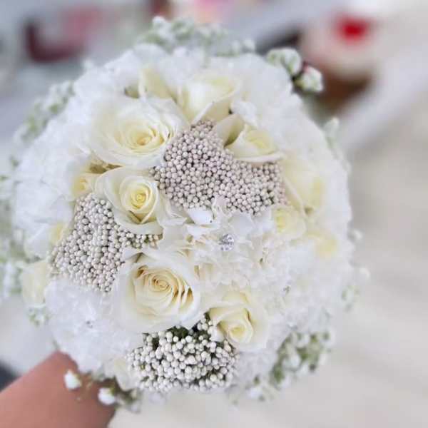 White rose bouquet with pearl-like accents and lace details