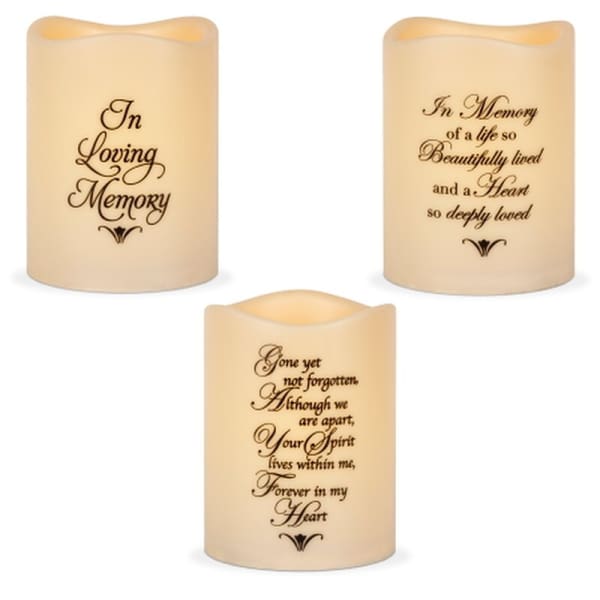 Three memorial candles with remembrance text