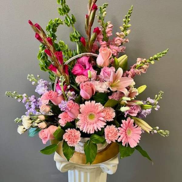 Pink mixed flower arrangement in a gold container