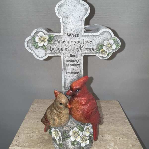 Decorative cross with a cardinal figurine and memorial text