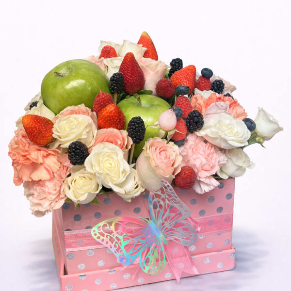 Fruit and flower arrangement in a pink gift box with a butterfly ribbon