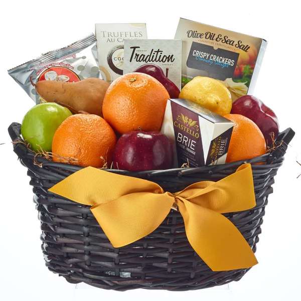 Gift basket with fruit, crackers, cheese, and chocolates in a black wicker basket