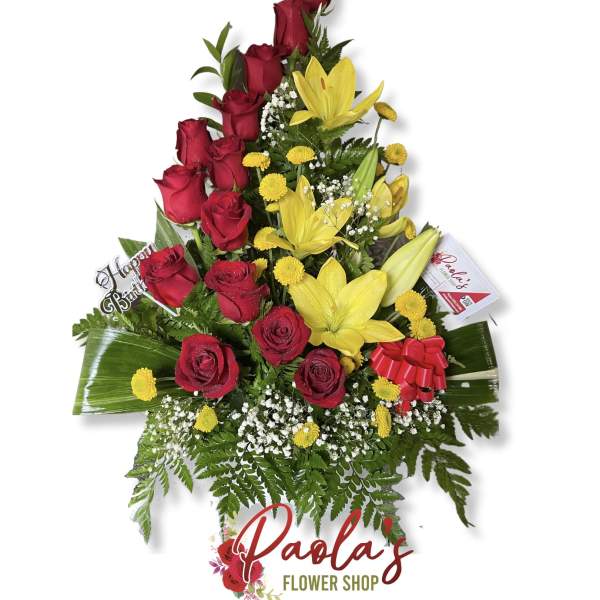 Tall bouquet of red roses and yellow lilies with a birthday pick