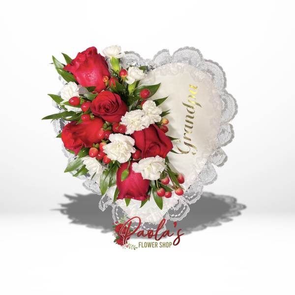 Heart-shaped bouquet of red roses and white carnations with lace trim