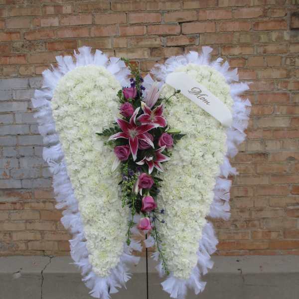 Heart-shaped white floral standing spray with pink lilies and roses