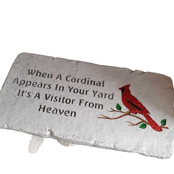 Decorative stone plaque with a red cardinal and quote text