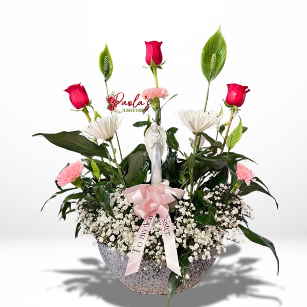 Pink roses and white daisies in a bowl planter with a ribbon and figurine