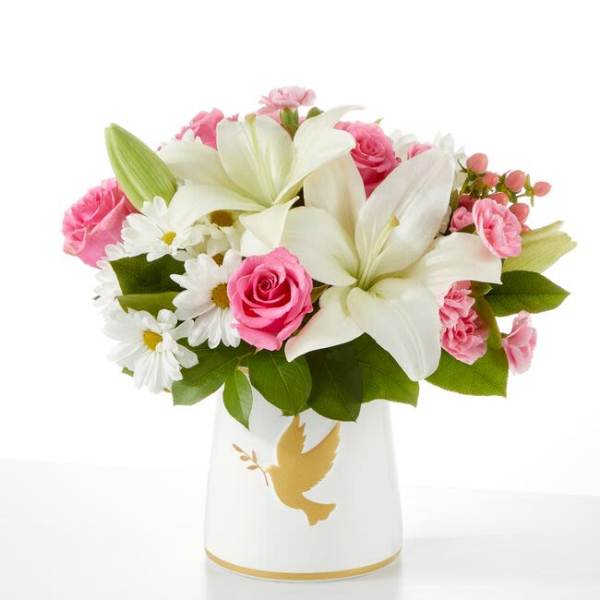 Pink and white bouquet in a white vase with a gold dove design