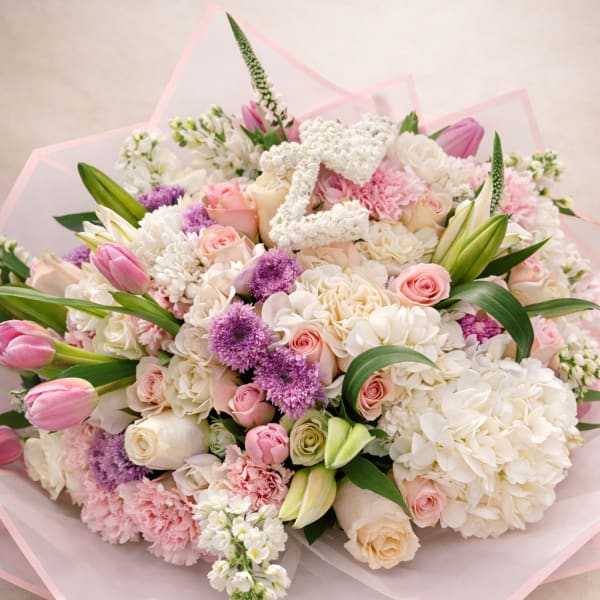 Pink and white mixed bouquet with roses, tulips, and hydrangeas