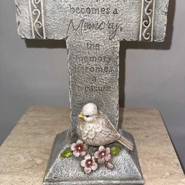 Decorative memorial cross with a bird and flowers