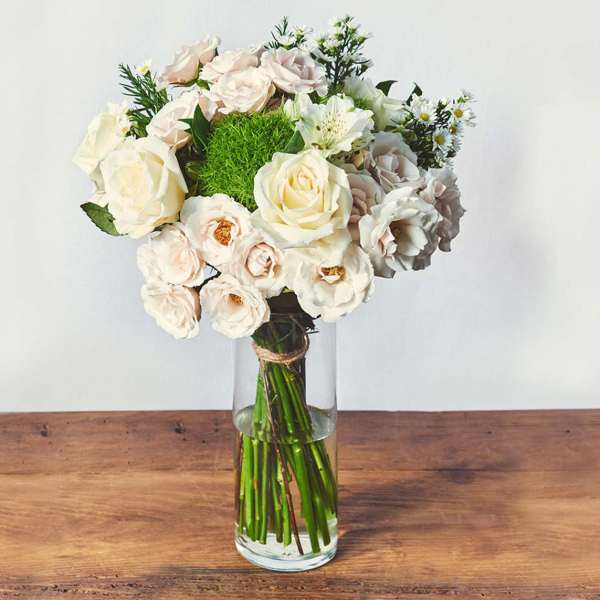 Cream and blush roses in a clear glass vase