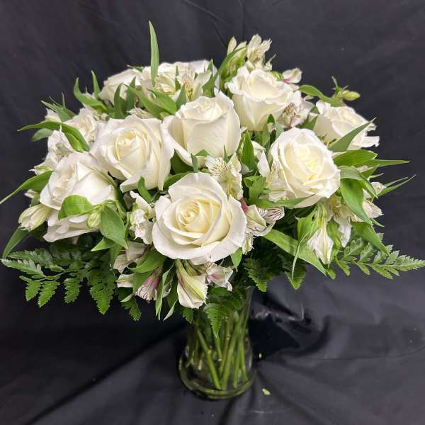 White rose bouquet in a clear glass vase