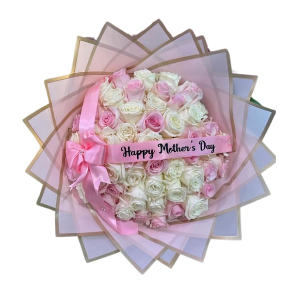 Pink and white rose bouquet wrapped in pastel paper with a Mother's Day ribbon