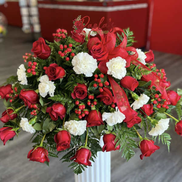 Large bouquet of red roses and white carnations with berries