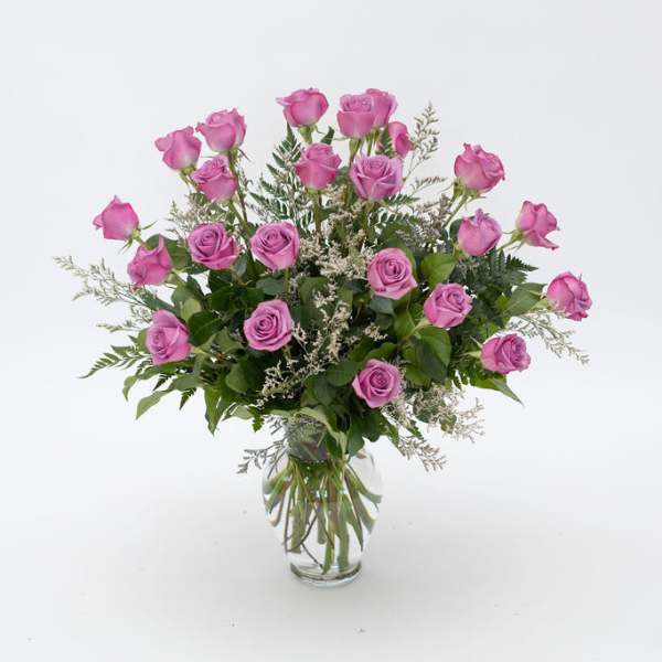 Pink roses arranged in a clear glass vase