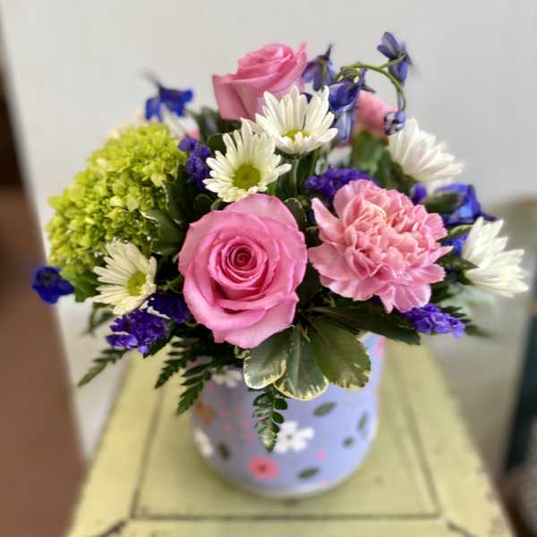 Pink roses and carnations with white daisies in a decorated vase