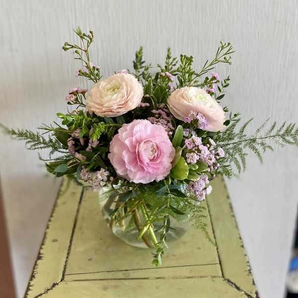 Pink ranunculus bouquet in a clear glass vase