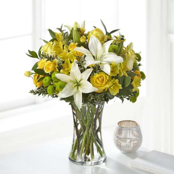 Yellow and white bouquet in a clear glass vase