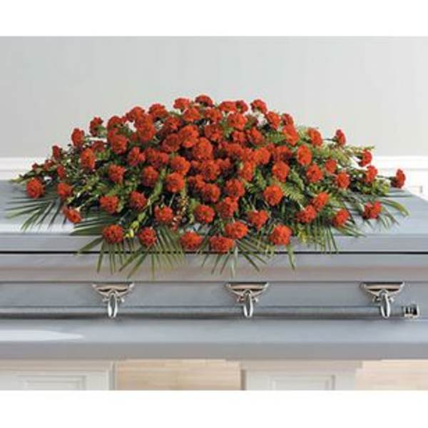 Red floral casket spray on a gray coffin