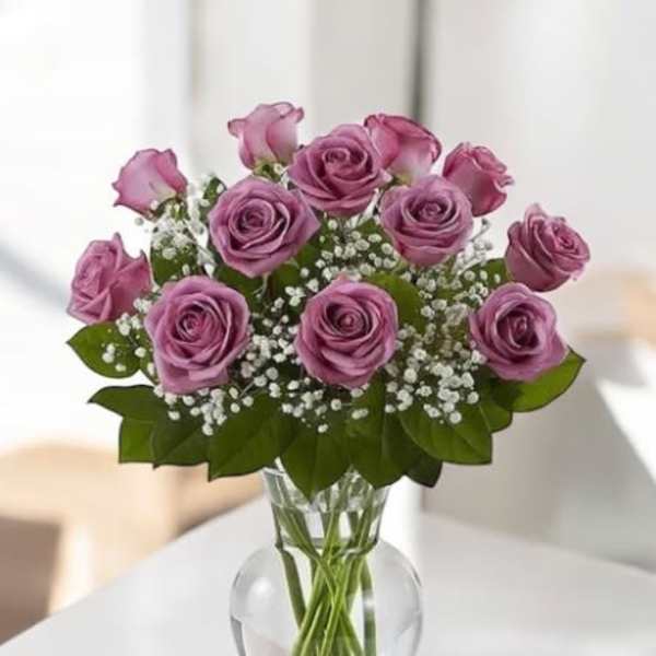 Pink roses arranged in a clear glass vase